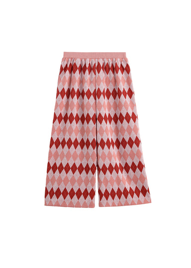 A pair of wide-leg pants featuring a red and pink argyle diamond pattern on a white base, with a solid pink waistband, shown against a plain white background.