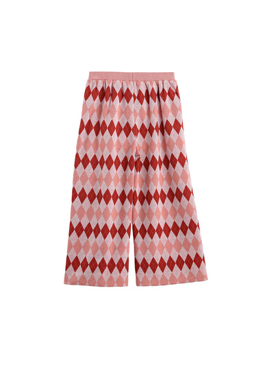 A pair of wide-leg cropped pants featuring an argyle pattern in shades of red, pink, and white, displayed against a solid white background.