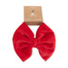 Red bow hair accessory on a white background with 'Angel Dear' packaging.