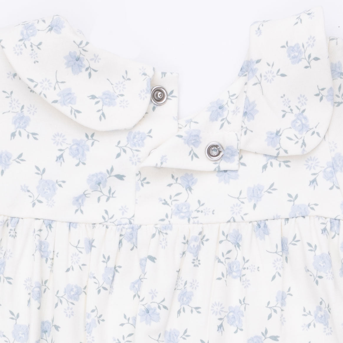 Floral-patterned shirt with small blue flowers on a white background