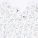 Floral-patterned shirt with small blue flowers on a white background