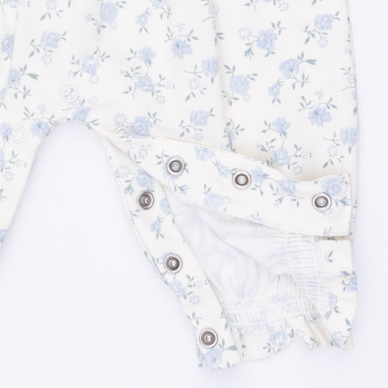 Floral-patterned fabric with snaps on a white background