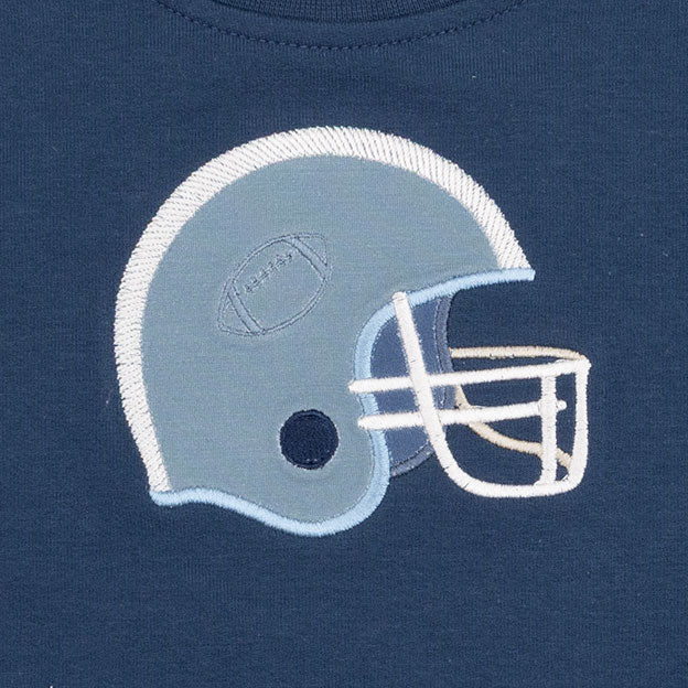 Close-up of a navy blue fabric garment featuring an embroidered football helmet graphic in light blue and white.