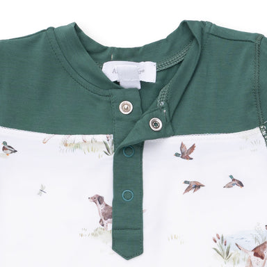 Green and white baby romper with dog and duck pattern on a white background