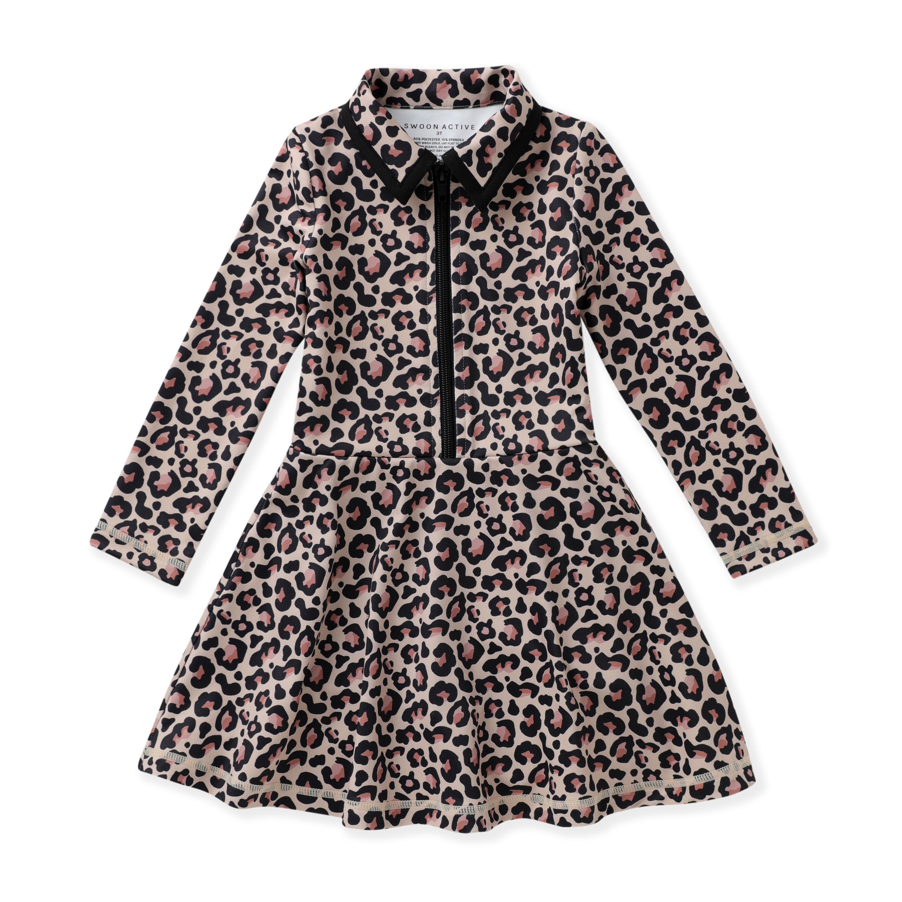 A long-sleeve girl's tennis dress with a leopard print pattern in beige, brown, and black, featuring a black collar, black tie detail at the neckline, and a black front zipper.