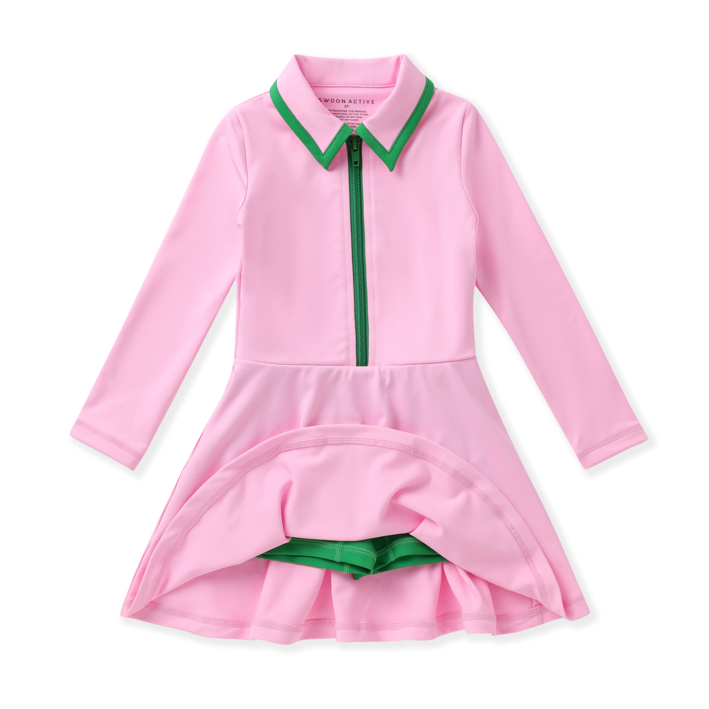A pink long-sleeve dress with a green collar, green zipper detail, and green built in shorts, displayed on a clean white background.