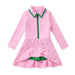A pink long-sleeve dress with a green collar, green zipper detail, and green built in shorts, displayed on a clean white background.