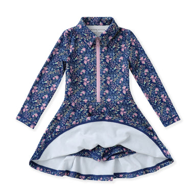 A girls' long-sleeve floral tennis dress with a half-zip front, standing collar, and flared skirt, shown flat against a white background. The exterior has a navy blue base with pink and light blue floral print, while the interior lining is white.