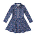 A girls' long-sleeve tennis dress with a navy blue floral print, featuring a pink zipper at the collar and a flared skirt, shown flat on a white background.