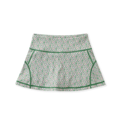 A high-waisted athletic skirt with a dense green, pink, and white floral pattern, featuring solid green contrast piping along the seams, displayed on a clean white background.