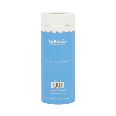  cylindrical puzzle packaging with blue label and white lid on a white background