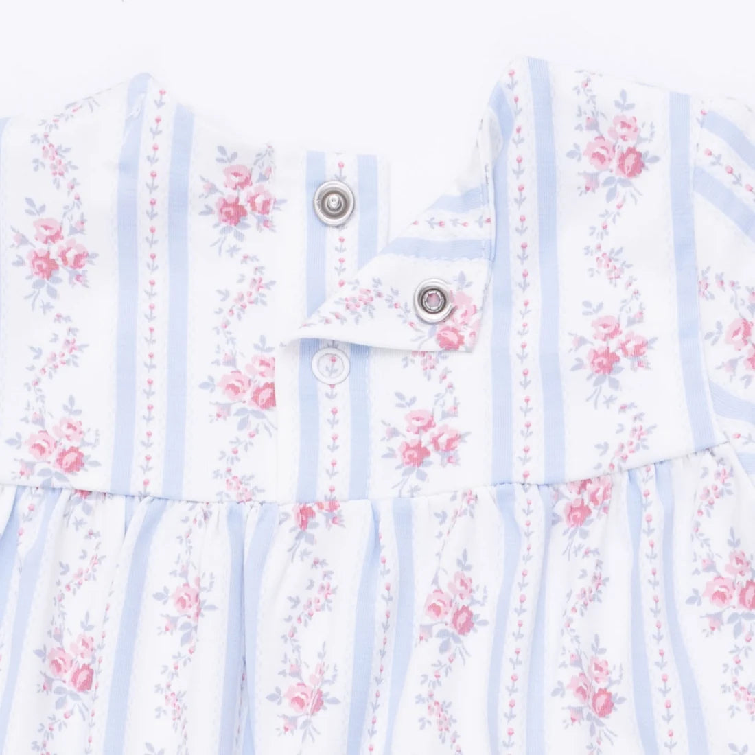 Floral patterned romper with snaps on a white background