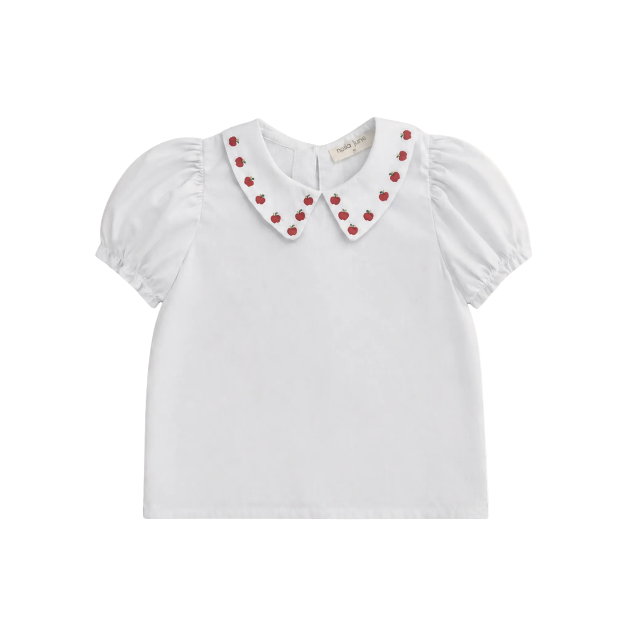 White blouse with red apple embellishments on a white background