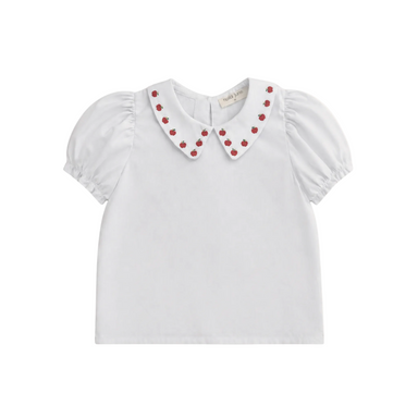 White blouse with red apple embellishments on a white background
