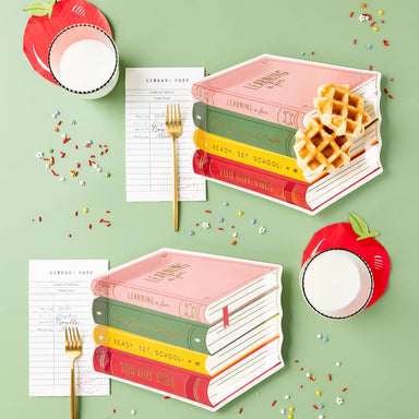 Apple shaped napkins with books and a fork
