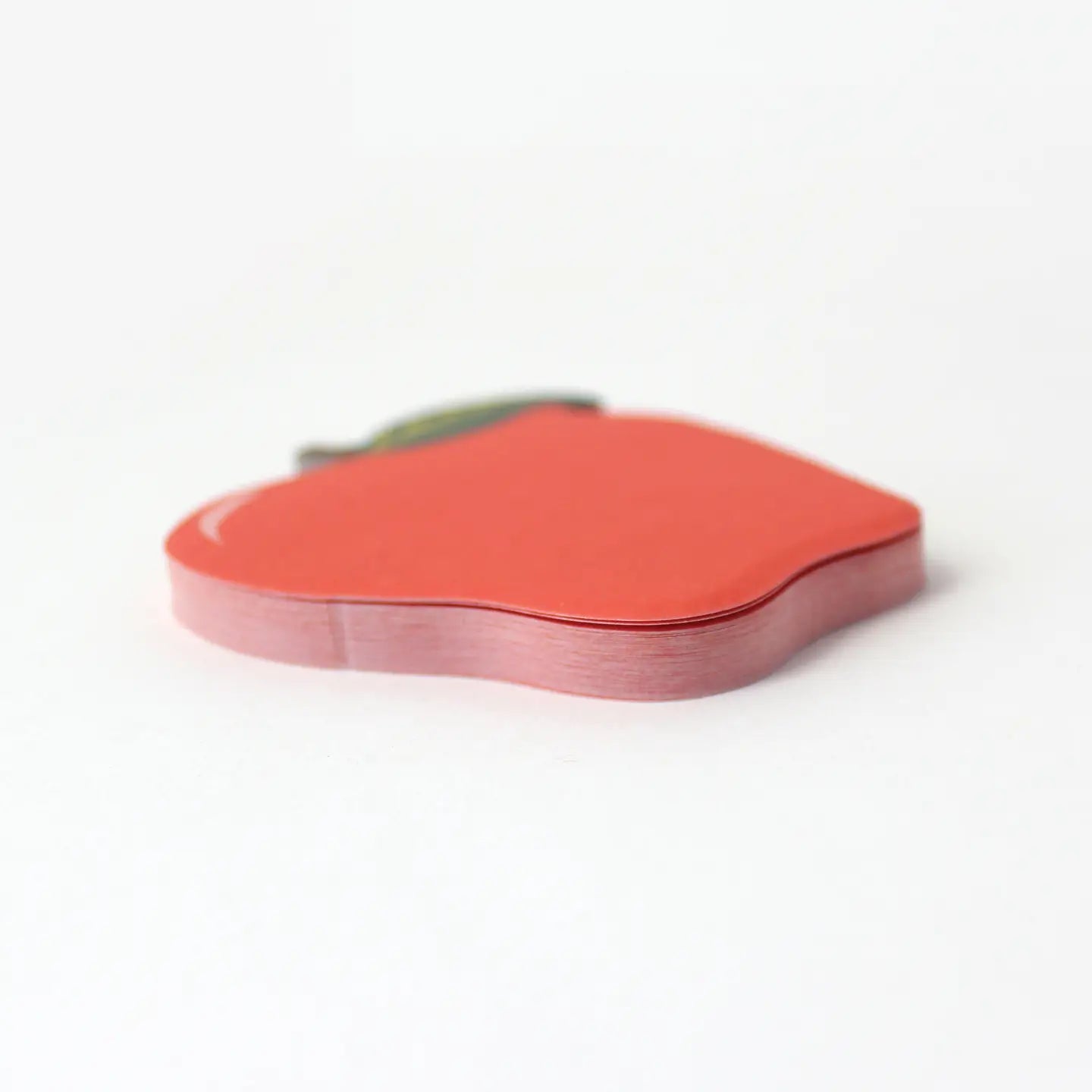 Red apple-shaped object on a white background