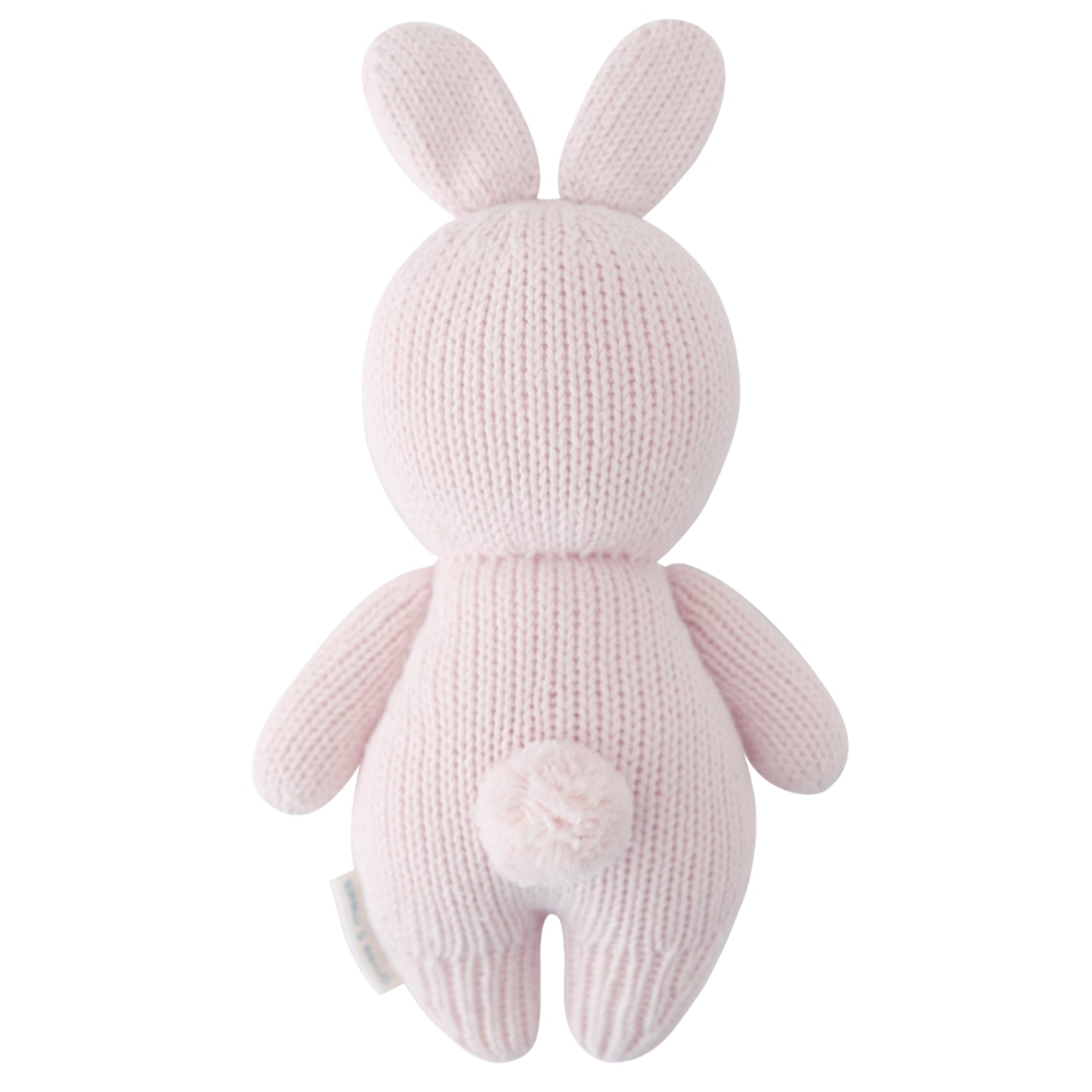 Knitted pink bunny toy on a white background