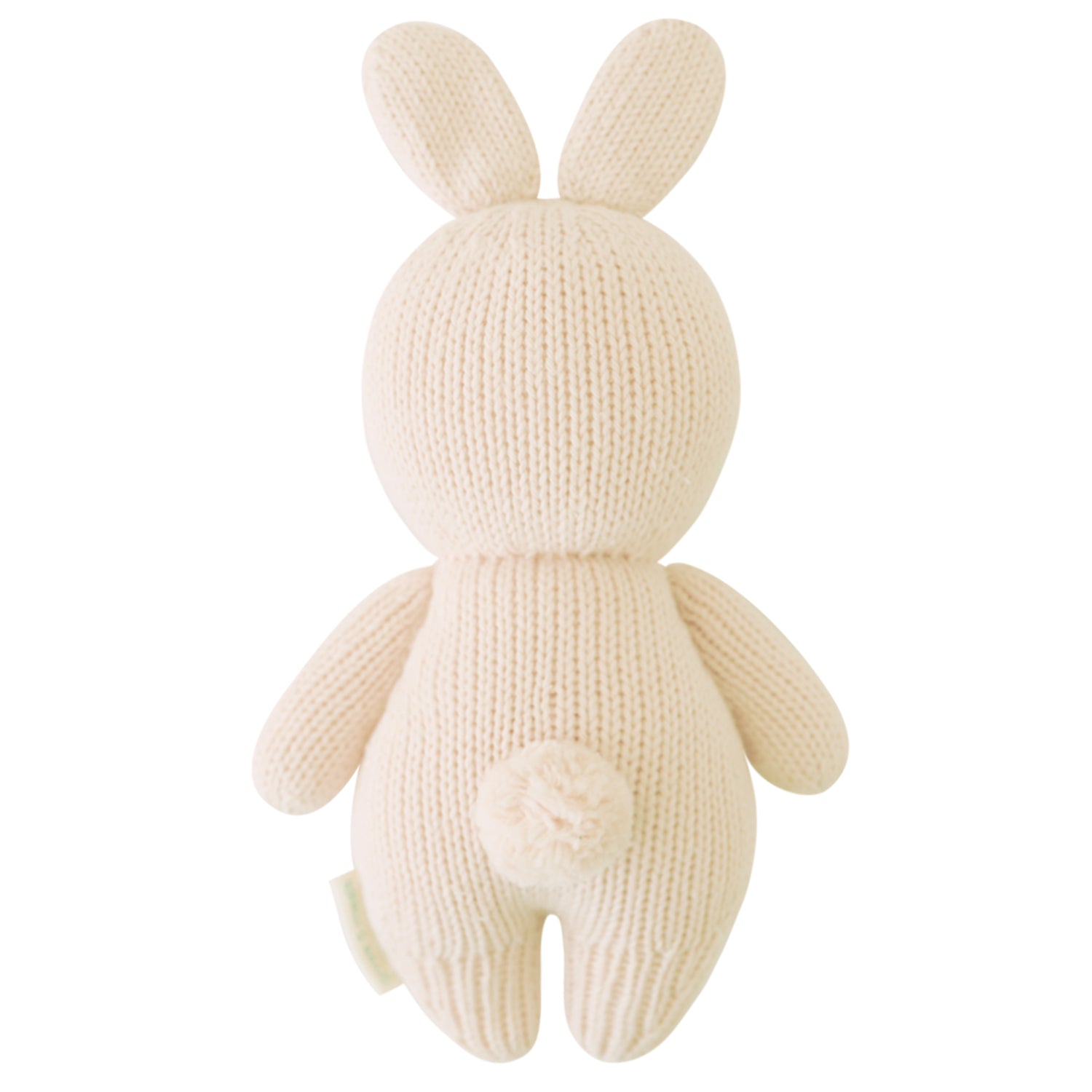 Knitted cream-colored bunny toy on a white background