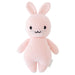 Knitted pink bunny toy on a white background