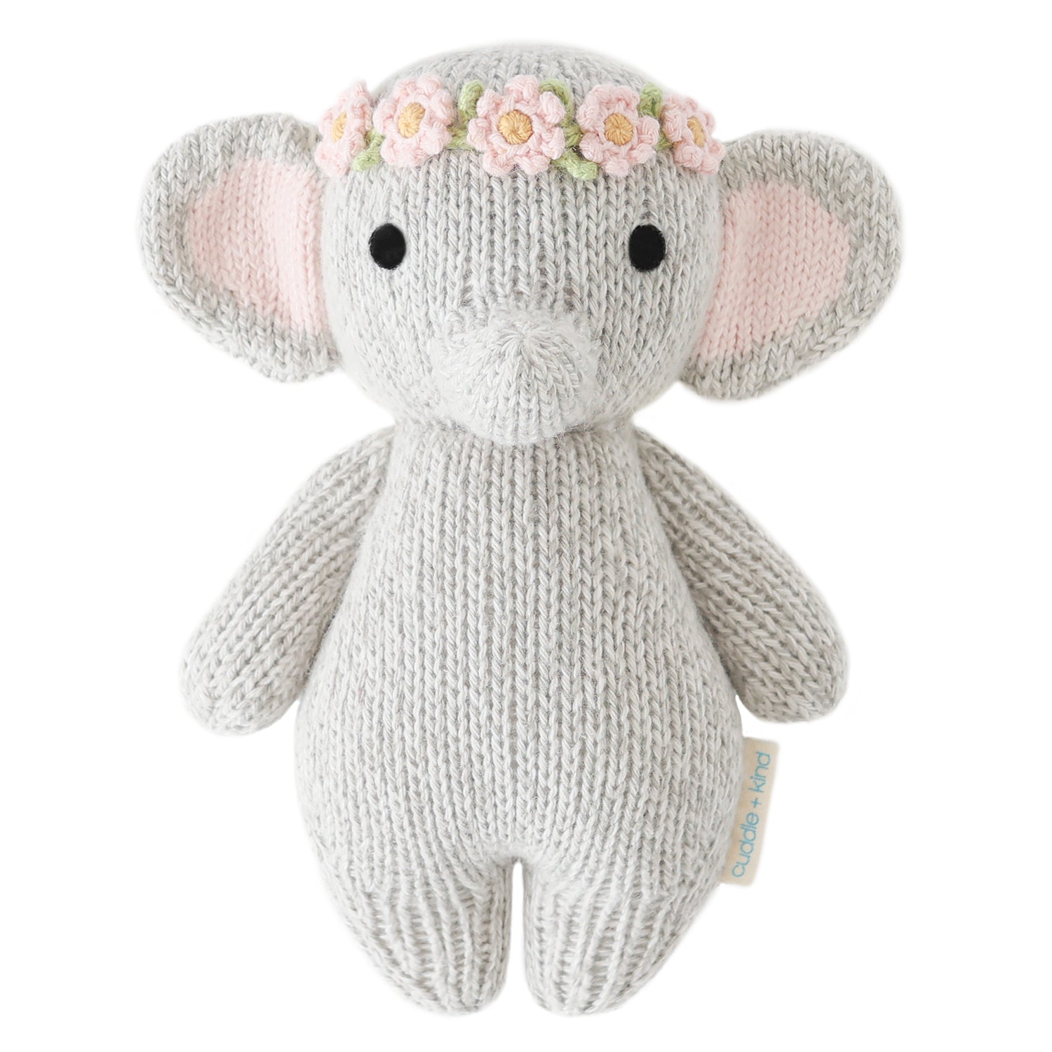 Knitted elephant toy with a flower crown on a white background