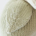 Close-up of a knitted fabric with a textured pattern on a light background