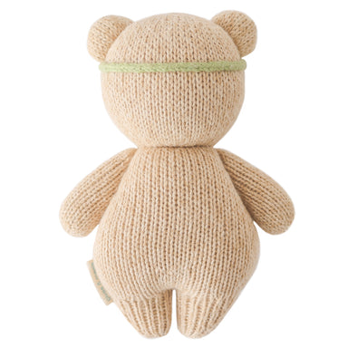 Knitted teddy bear toy on a white background