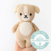 Knitted dog toy held by a hand with Good Housekeeping Award badge on a white background