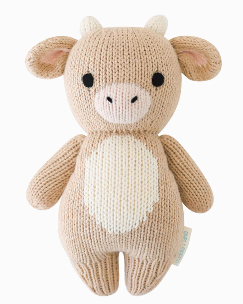 Knitted toy cow on a white background
