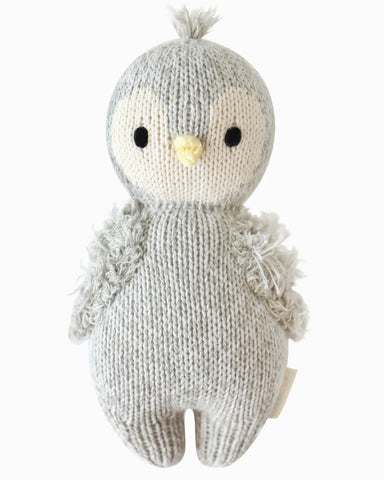 Knitted toy penguin on a white background