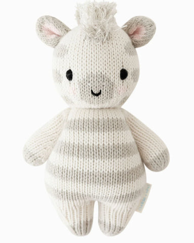 Knitted toy zebra on a white background