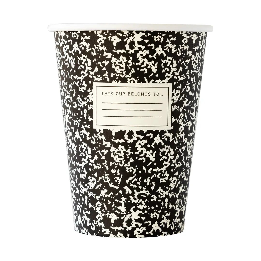 Black and white composition patterned paper cup with a label on a white background