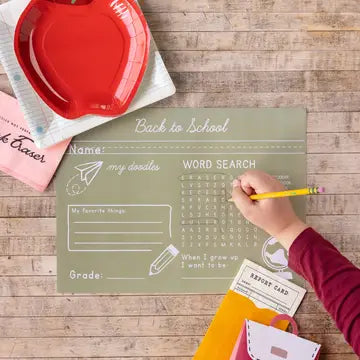 Back-to-school themed paper with a word search and other activities on a wooden surface.