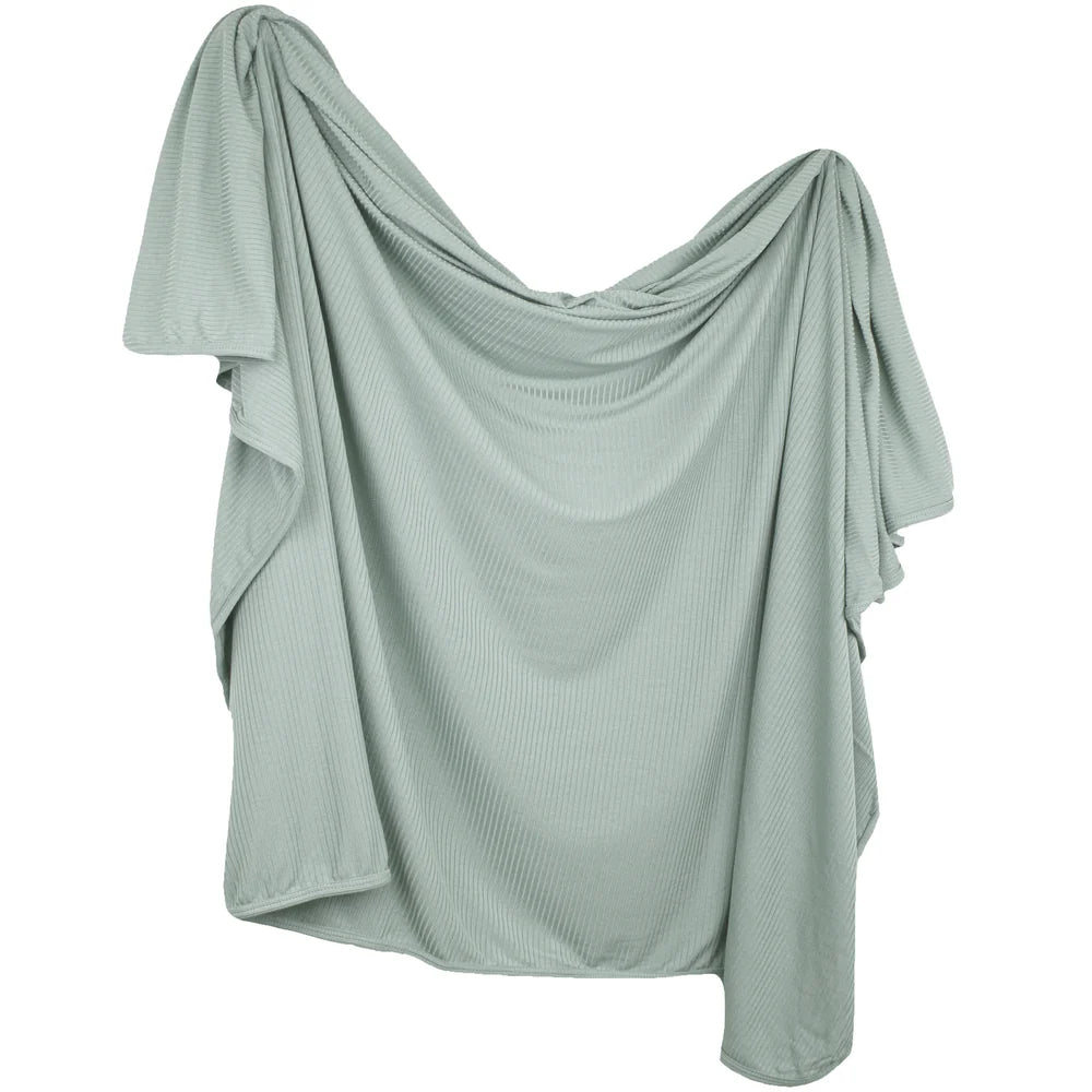 A sage green draped top with a textured, ribbed fabric and asymmetrical flutter sleeves, shown against a plain white background.
