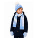 A young boy wearing a matching winter outfit with a navy blue coat, a light blue and white striped knit beanie with a pom-pom, a matching striped scarf, and striped knit mittens, photographed against a solid white background.