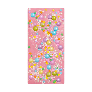 Pink chocolate bar with colorful bubble pattern on a white background