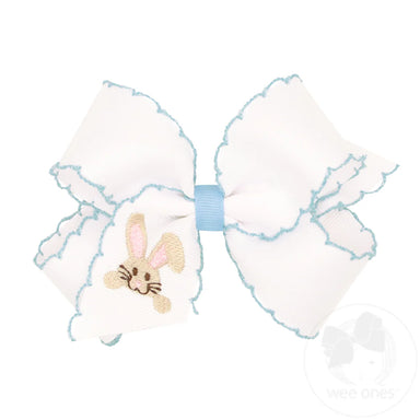 Large white bow with a small embroidered bunny on a white background