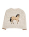 A cream-colored knit sweater featuring a large, detailed knitted horse motif on the front, with ribbed cuffs and hem.