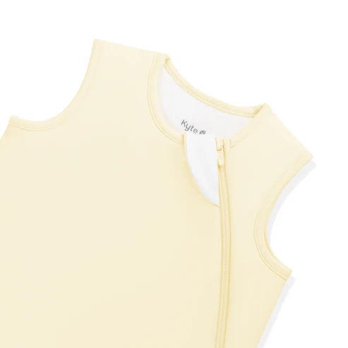 Light yellow sleeveless sleep bag with a zipper on a white background
