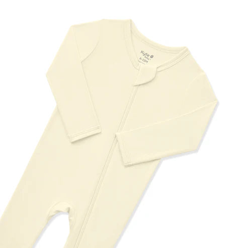 Cream-colored baby outfit on a white background