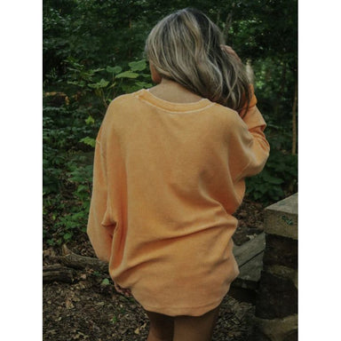 back of orange corded sweatshirt