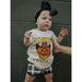 toddler girl wearing white short sleeve tee with graphic "Howdy Pumpkin" and orange jack-o-lantern wearing a cowoby hat and bandana