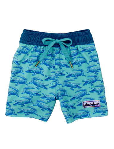 Blue swim shorts with alligator pattern on a white background