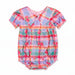 A baby girl's short-sleeve romper in a pastel plaid pattern with pink rose prints, featuring a scalloped Peter Pan collar and ruffled trim.