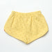 Yellow shorts with smiley face pattern on a white background