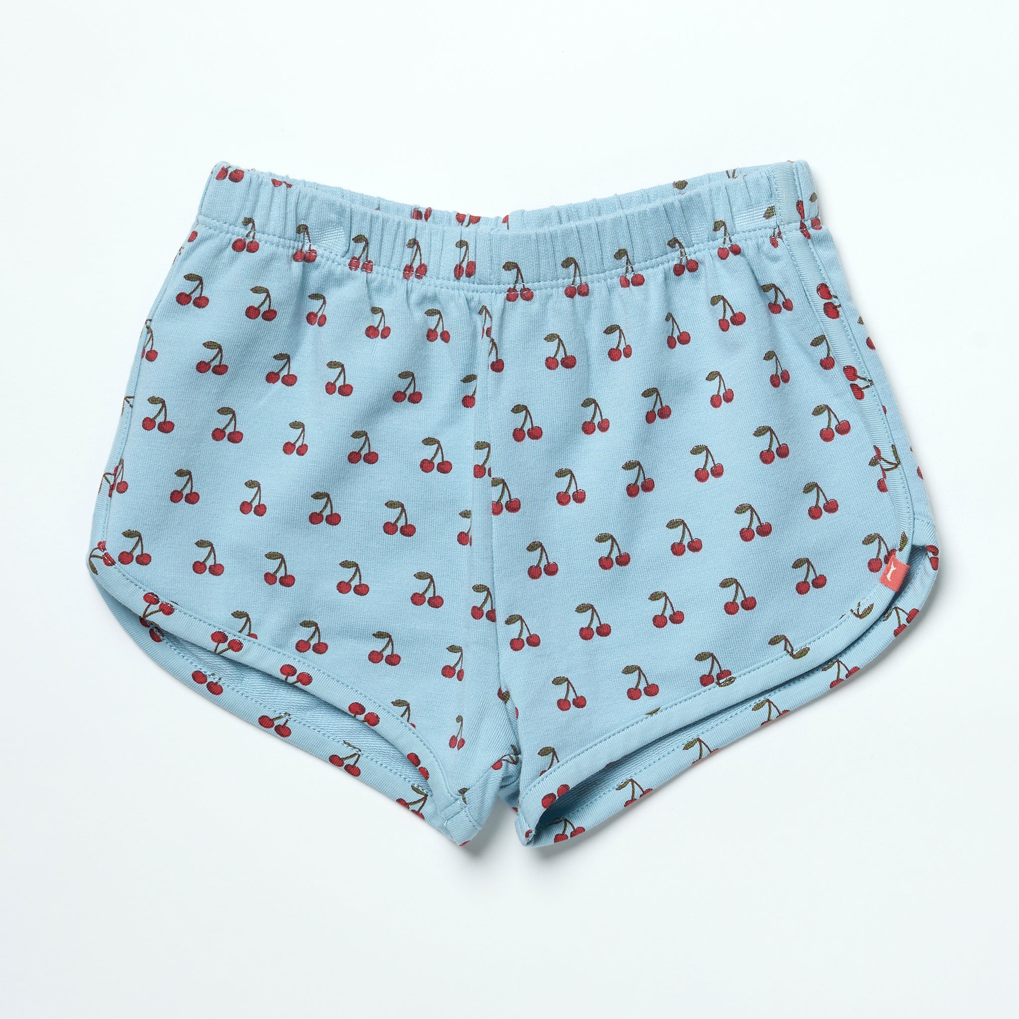 Light blue shorts with cherry pattern on a white background