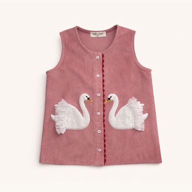 A sleeveless dusty rose corduroy dress for toddlers, featuring two white embroidered swans facing each other on the front, with a scalloped red button placket and white buttons.