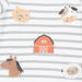 Close-up of a baby garment with horizontal gray and white stripes and embroidered farm-themed motifs including a pig, cow, barn, horse, and sheep.