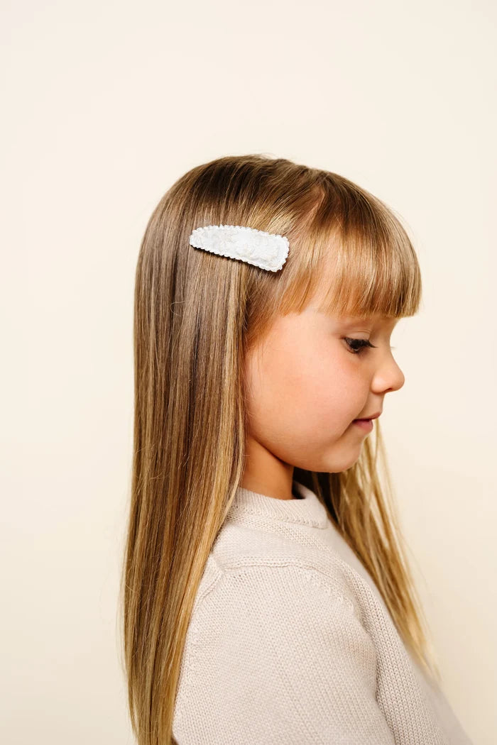 Young girl with a Cream Daisy Scallop Barrette in her hair
