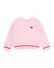 A pink waffle-knit long-sleeve sweater with a small red heart on the left chest, featuring red and white striped ribbed cuffs and hem, shown on a plain white background.