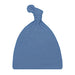 A dusty blue knit baby hat with a knotted top, shown against a plain white background.